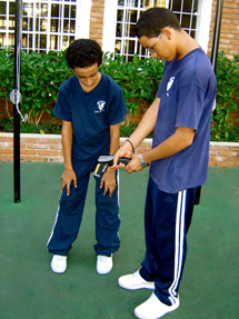 Students taking surface temperature of the green playground.