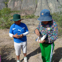 Two young student take notes in the field.