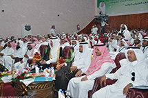 Several people sit looking at a presentation together.