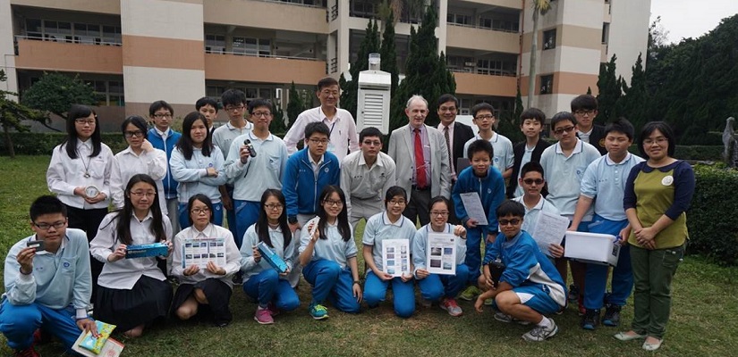 Several student and adults pose for a group photo.