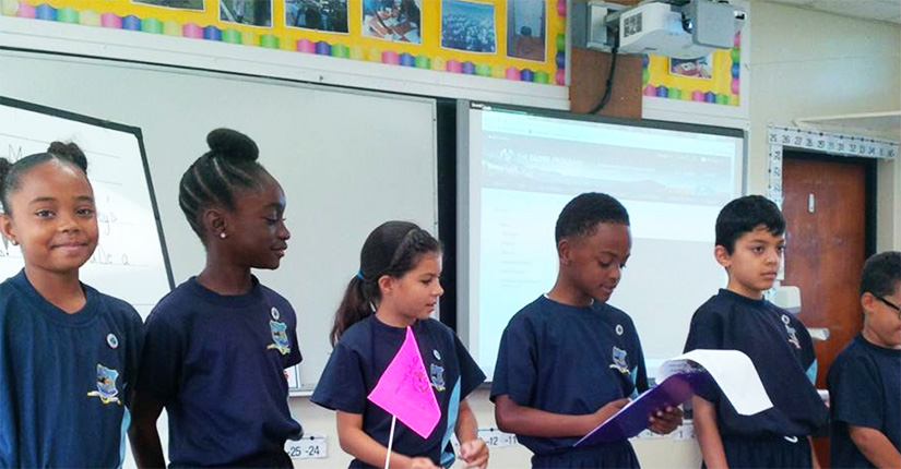 Five students stand in a line.