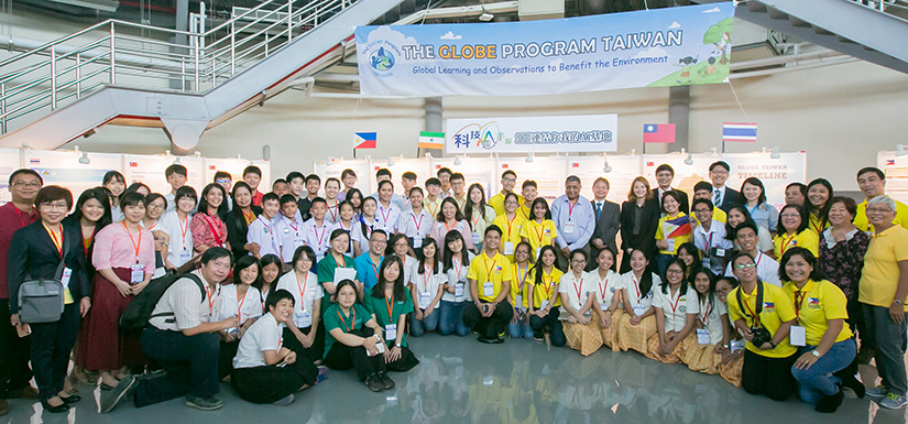 A large group of students and teachers stand together for a picture.