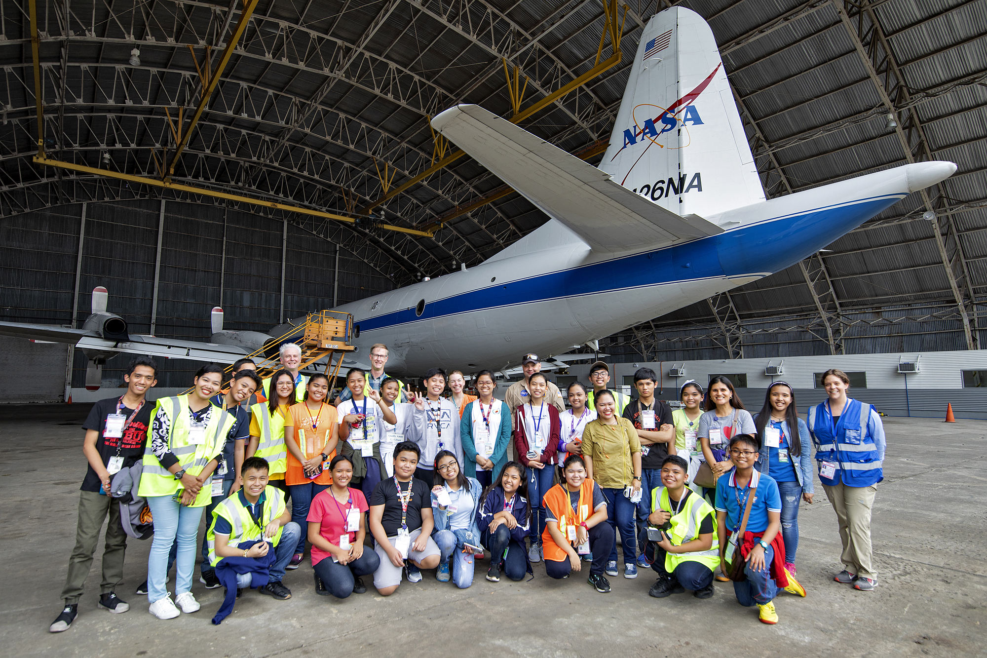Students and teachers from Batasan Hills National High School and Bagong Silangan High School pose by the NASA P-3 aircraft after their tour of the NASA hangar at Clark International Airport, Philippines, on 14 September 2019.