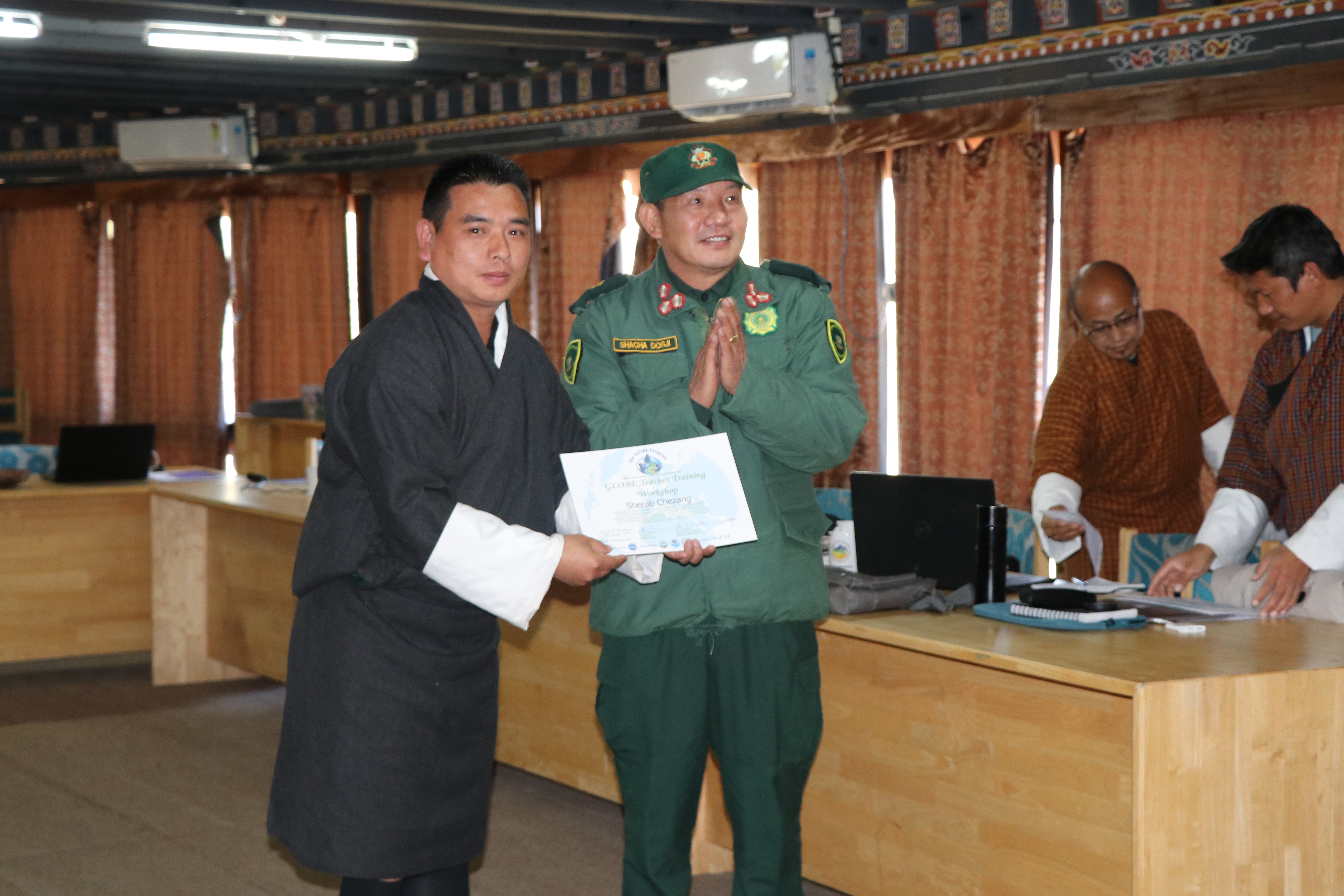 Director Shacha Dorji, Ugyen Wangchuck Institute for Conservation and Environment Research, presenting teachers with GLOBE teacher training certificate