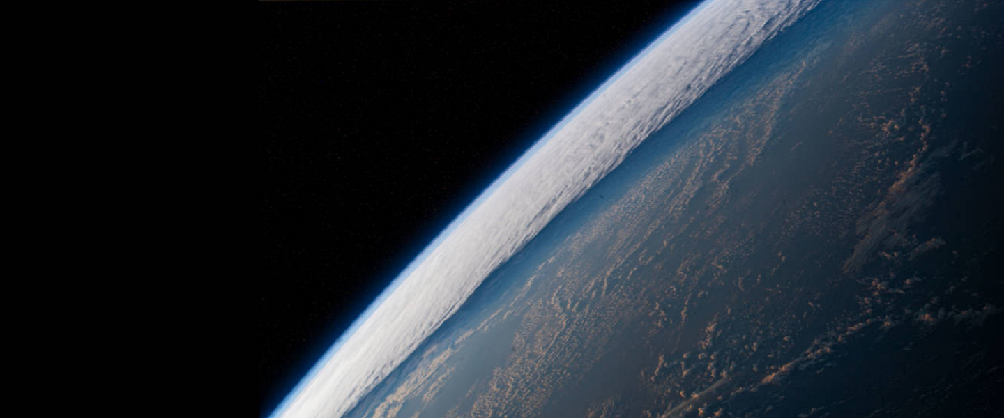 A view of the planet Earth from space.  This view only shows about a quarter of the planet with a view of the horizon on the left.