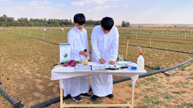 The picture shows students Faris and Dhari conducting field studies and applying study protocols.