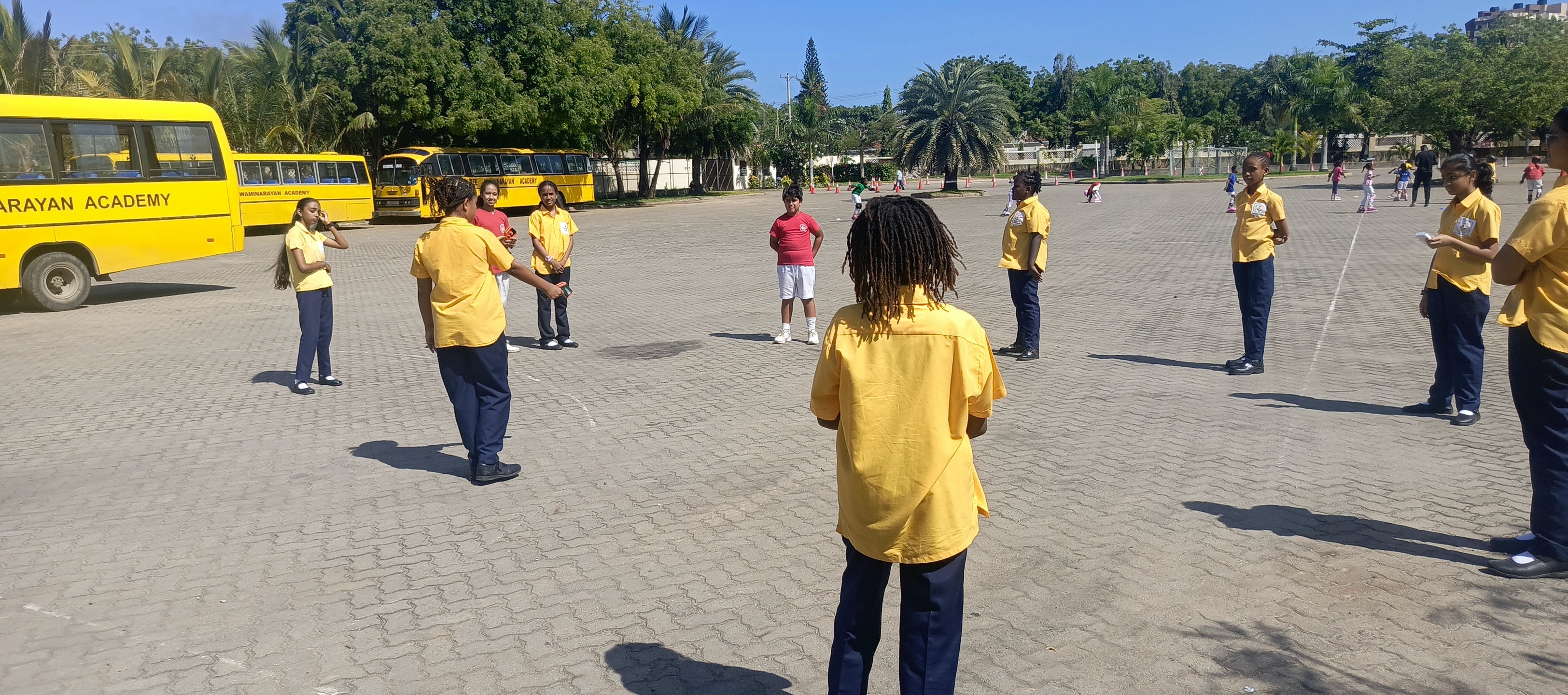 Kids taking surface temperature measurements on pavement.