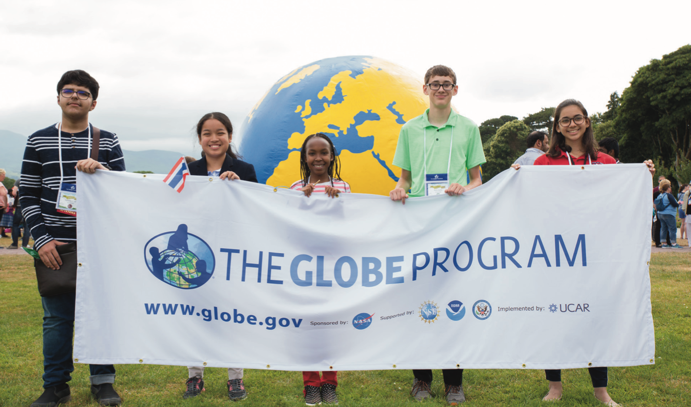 Five students hold GLOBE banner