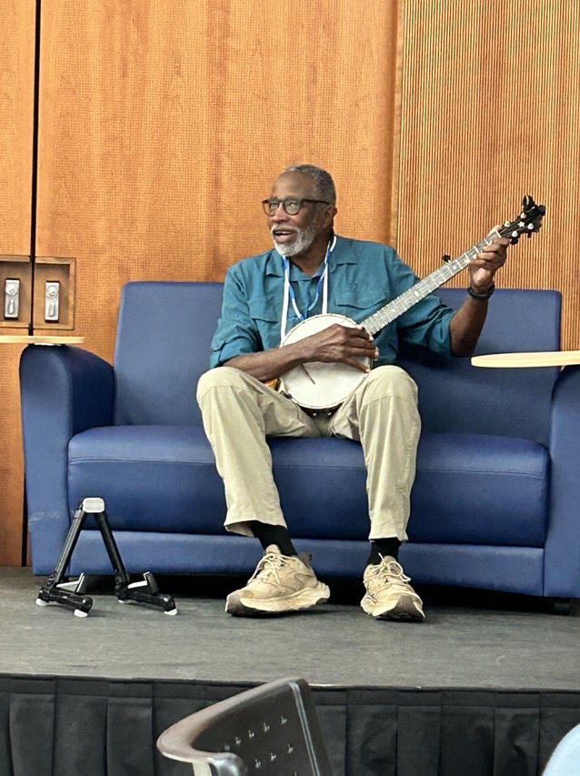 Dr. John Francis, The Planetwalker, played his banjo during his keynote at the 2024 GLOBE Annual Meeting