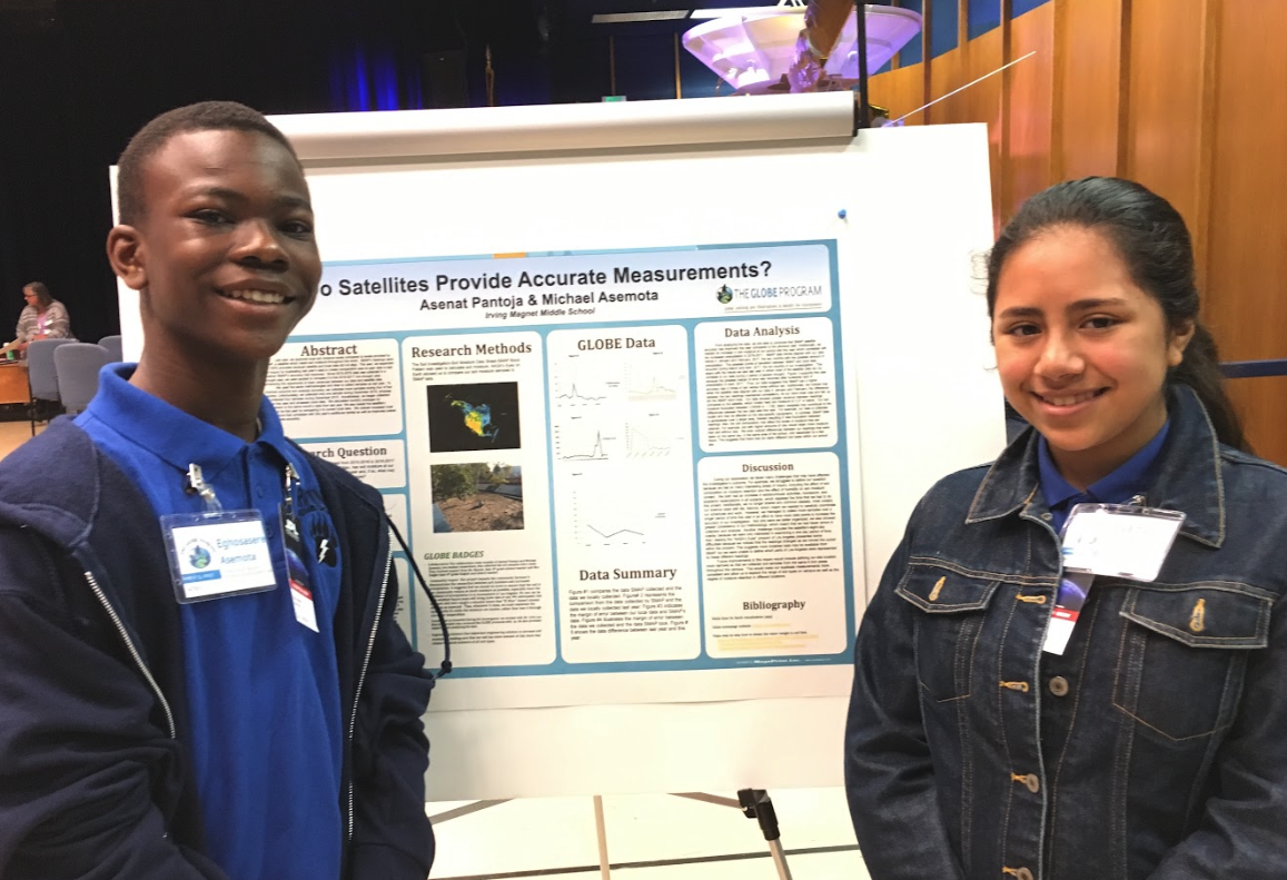 Two students present a poster at the SRS