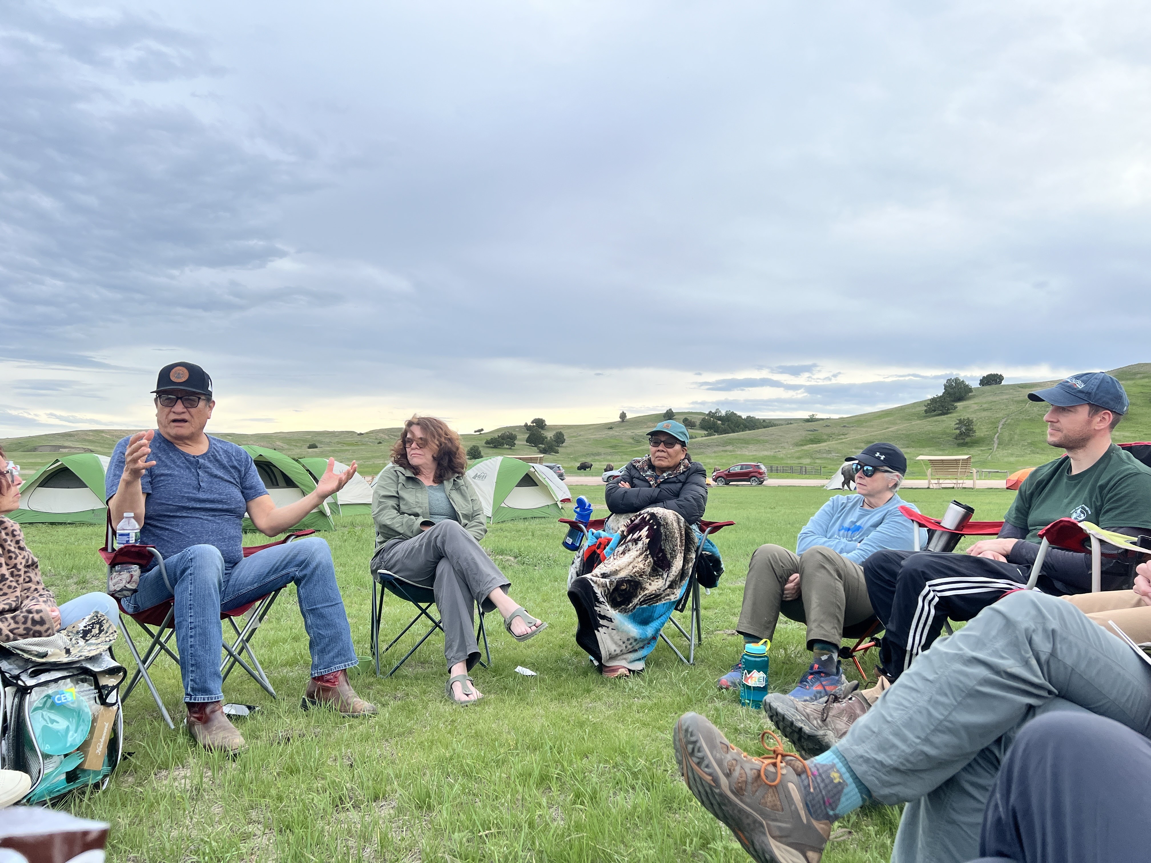 NARM participants sit in a circle at Sage Creek Campground for a discussion with Tony Ten Fingers.