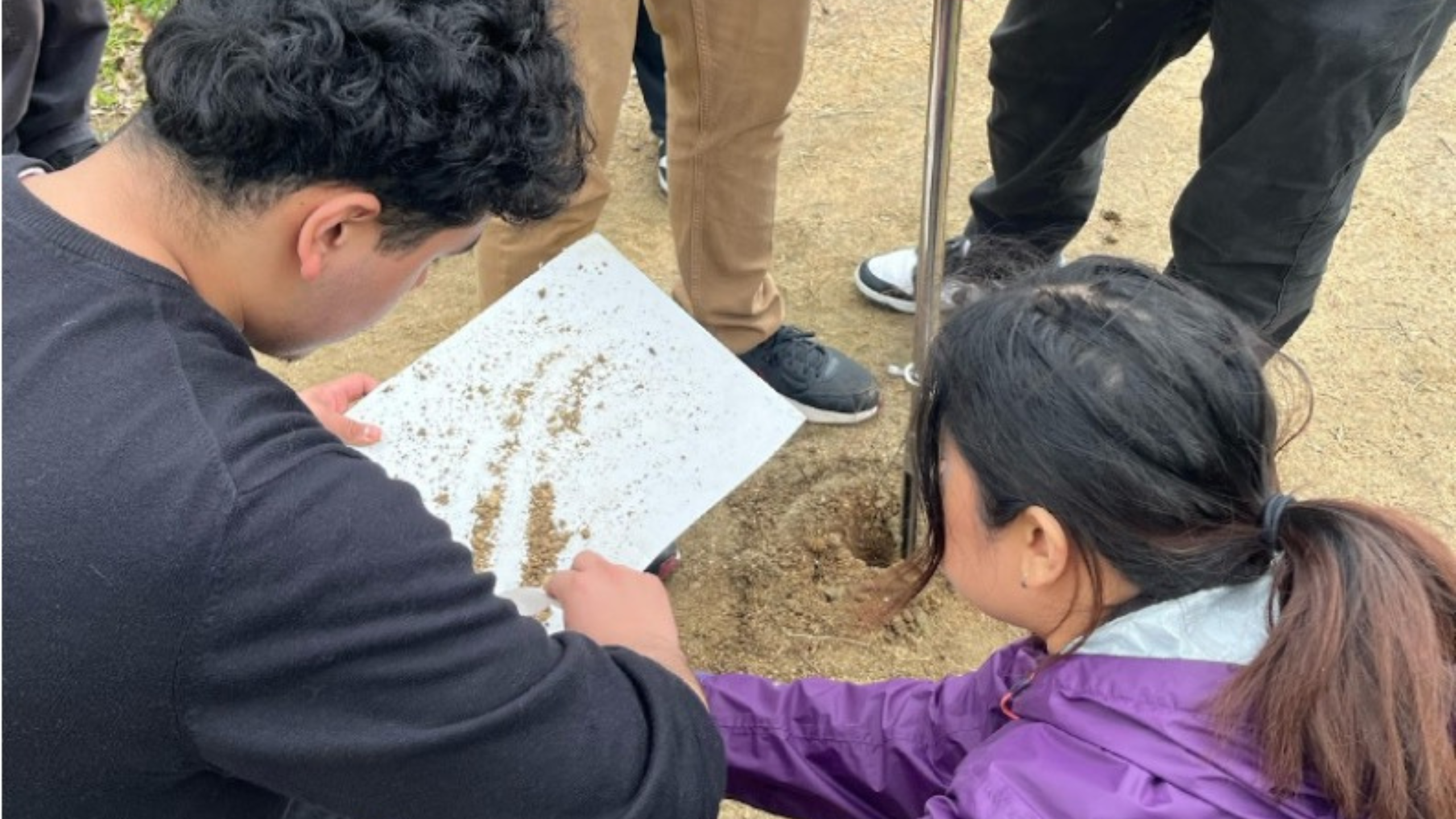 students collect soil samples