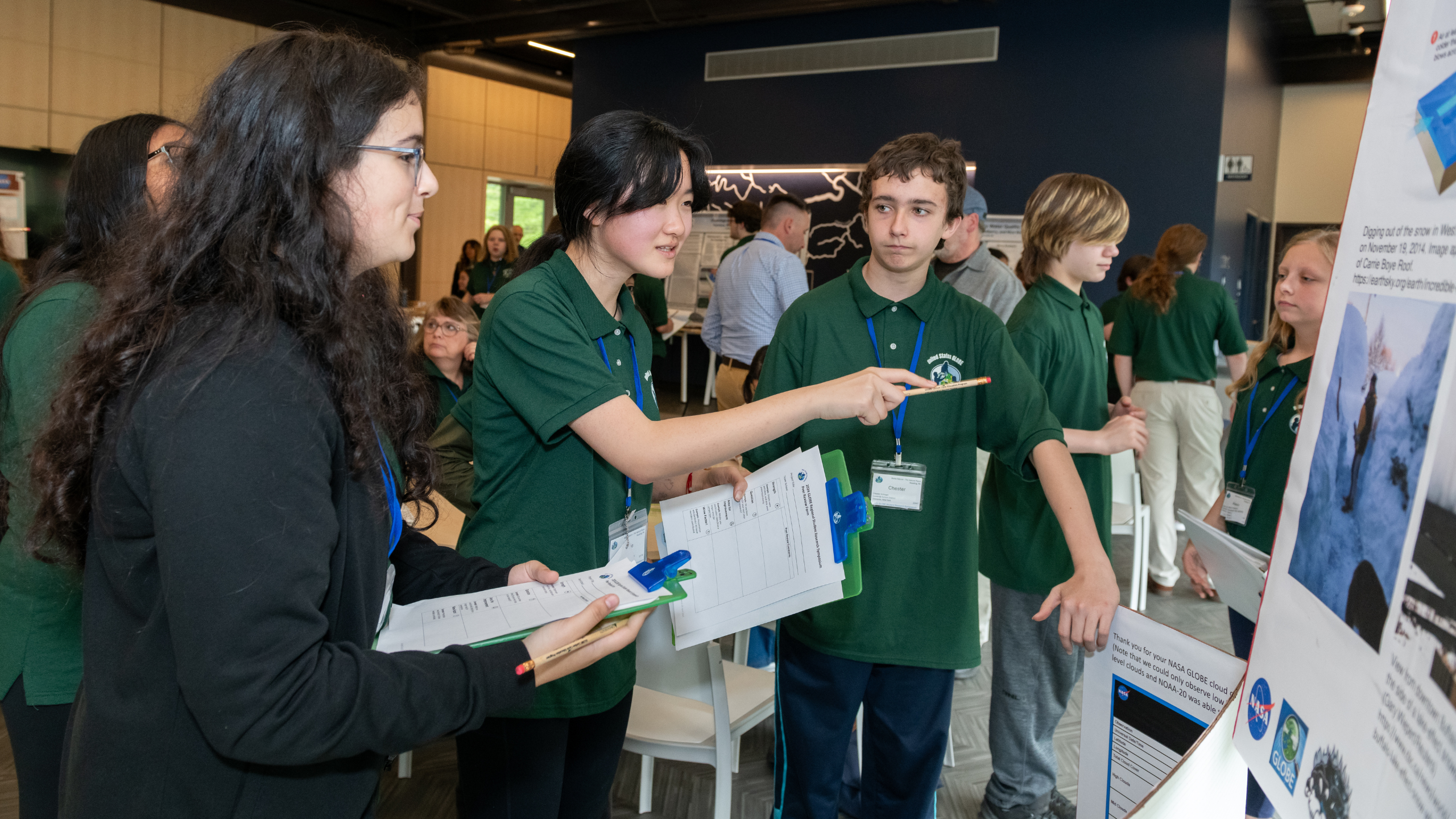 students review each other's posters at the student research symposium (photo by Susan L Angstadt